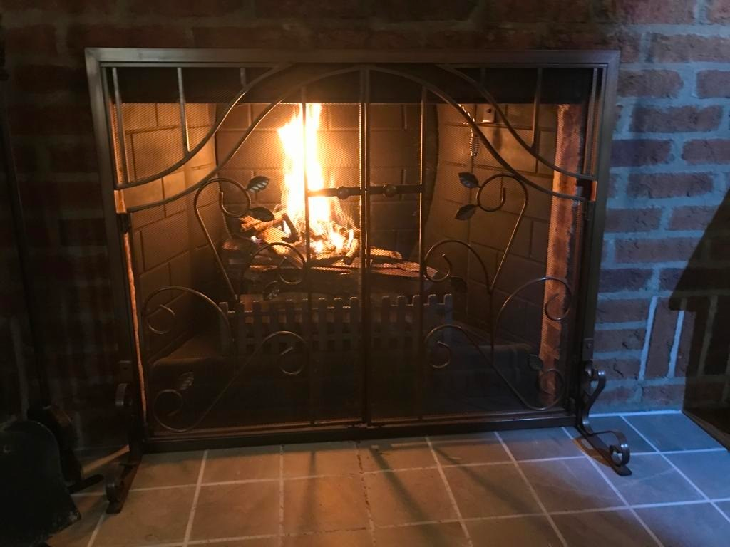 Finished brick fireplace with a clean firebox and hearth.